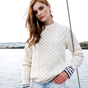 Lady wearing a white Aran Wool sweater