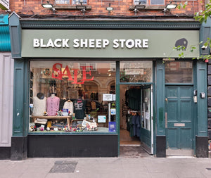 Storefront of Black Sheep Store with clothes on display 