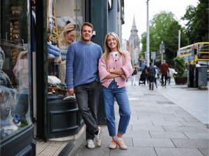 Paul & Laura - Sweater Shop Owners  standing outside one of the stores