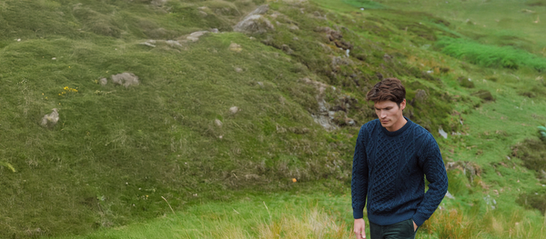 Man walking in Hills in Aran Sweater